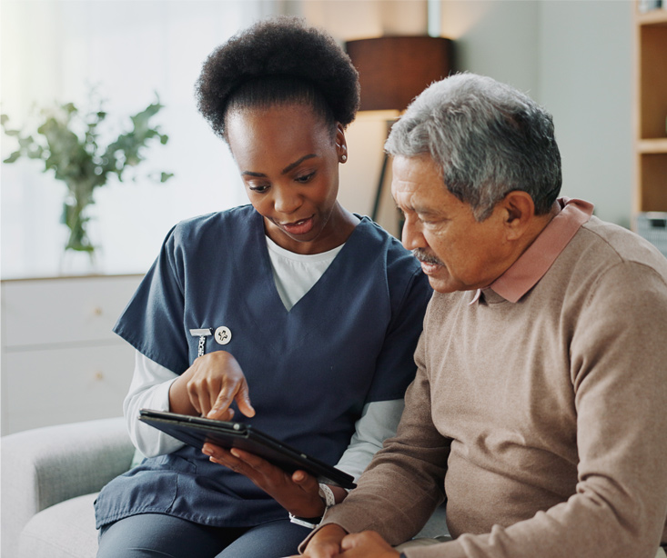 caregiver sitting with elderly man